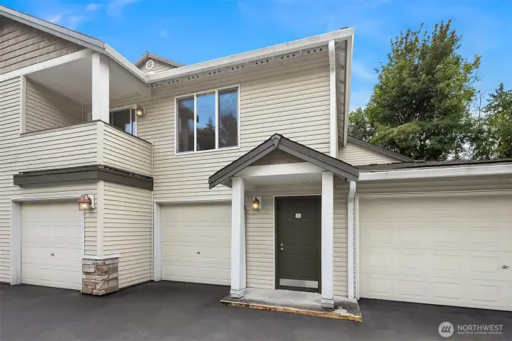 Front door to unit #A203 showing window in living room and outside deck.
