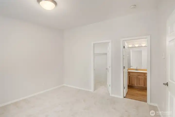 Primary bedroom with walk in closet and ensuite bathroom.