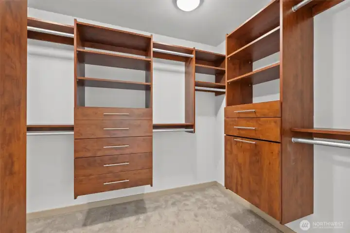 Walk-in primary suite closets with built-ins