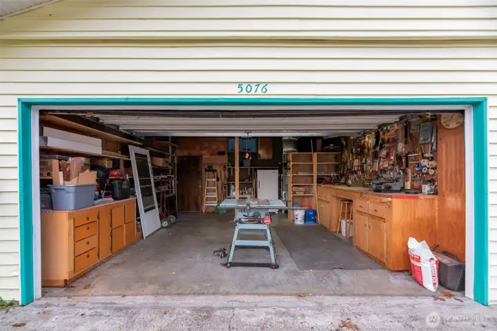 Two car garage with shop area, workbench, and lots of storage