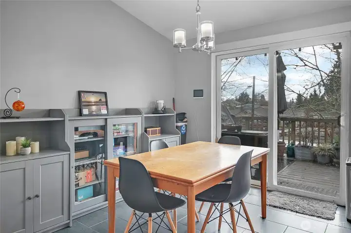 Vaulted ceiling in dining room with patio door to deck.