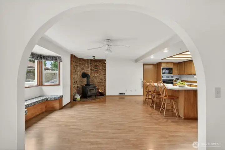 Arched doorway into the kitchen/family room. Great wood stove for the perfect warmth in the winter months.