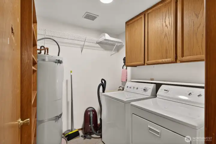 Nice utility room with overhead cabinets.