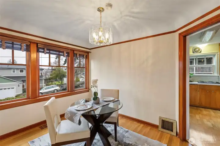 Dining room bathed in light from windows taking in the view.