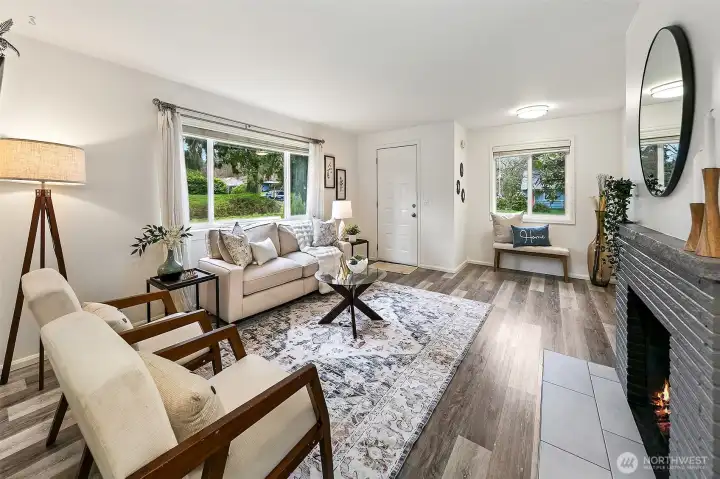 Sunlight pours through large windows into this welcoming living space, where classic mid-century warmth meets thoughtful modern updates.