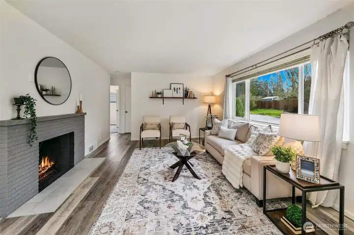 Anchored by a fireplace and open sightlines, the living room creates an inviting place to gather at the heart of this reimagined Lovell home.