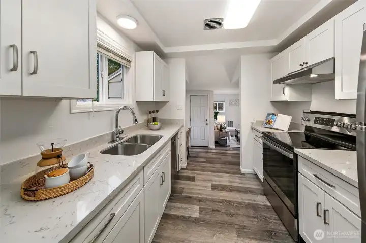 The kitchen blends modern updates with mid-century simplicity, creating a bright and inviting space where cooking, conversation, and everyday life naturally come together.