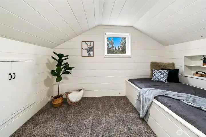 Charming built-in sleeping nook adds character and versatility to the upper level.