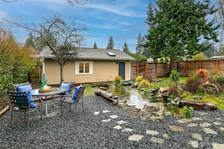 A peaceful garden patio invites outdoor dining and quiet moments surrounded by the calm of the fully fenced backyard.