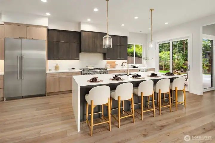 This dream kitchen offers quartz counters with a 10.5-foot waterfall island, Thermador appliances with smart features, and beautiful Bellmont soft close cabinets. This dream kitchen offers quartz counters with a 10.5-foot waterfall island, Thermador appliances with smart features, and beautiful Bellmont soft close cabinets.