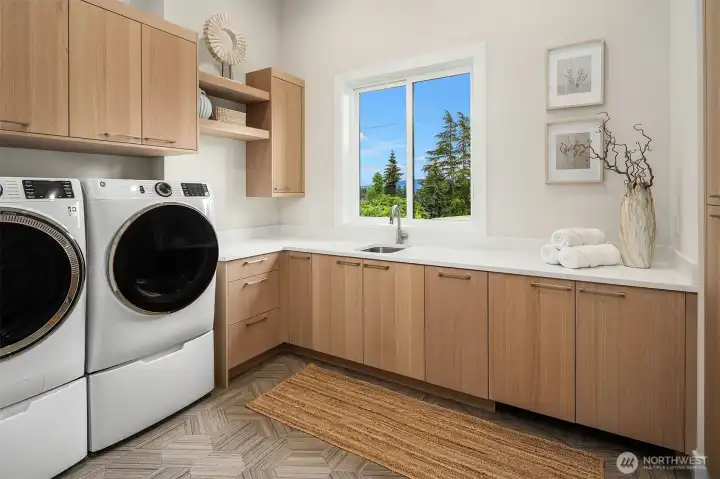 Even the laundry room is beautiful. Walls of cabinet storage, extra counter space with sink, and Washer/Dryer included. Even the laundry room is beautiful. Walls of cabinet storage, extra counter space with sink, and Washer/Dryer included.