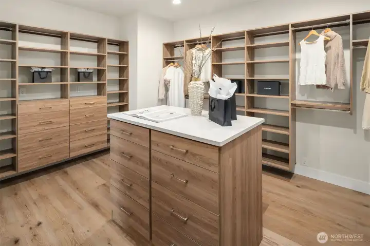 Custom primary closet with ample storage and organization. Custom primary closet with ample storage and organization.