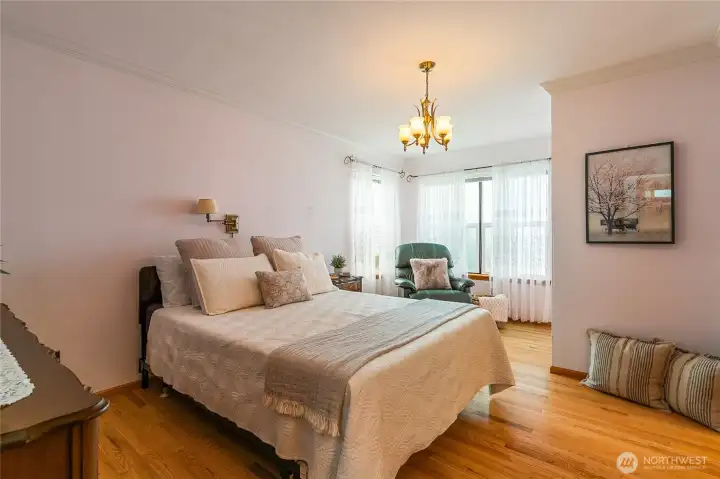 Spacious primary bedroom featuring a cozy reading nook, creating the perfect space to relax and unwind. Spacious primary bedroom featuring a cozy reading nook, creating the perfect space to relax and unwind.