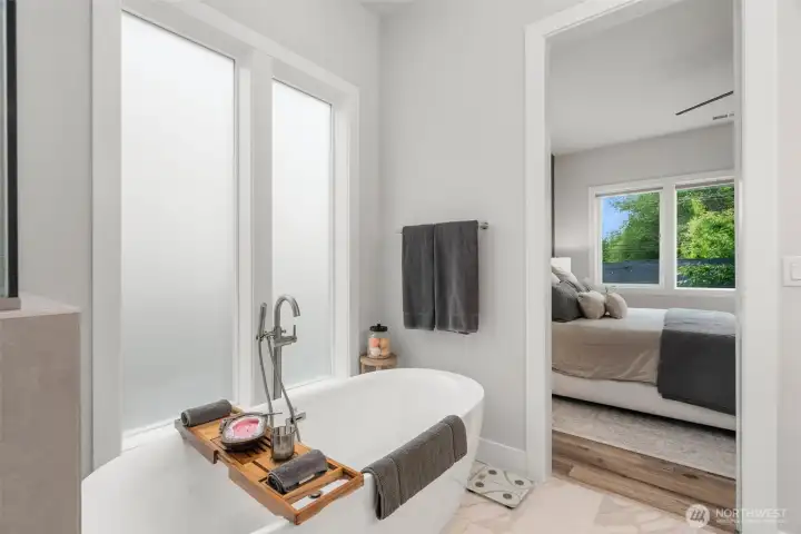 Spa-inspired, primary ensuite featuring a freestanding soaking tub.