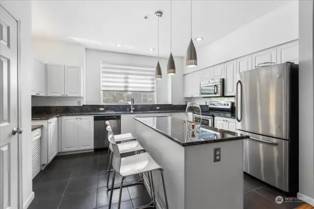 The kitchen has solid granite counter tops, stainless steel appliances.