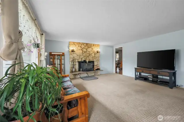 Main entrance opens up to the primary living space with stone fireplace.