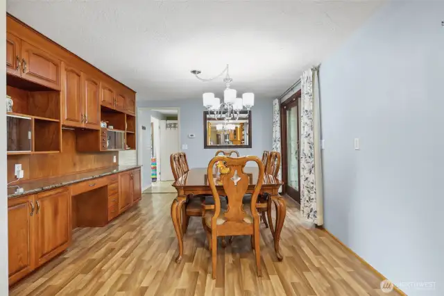 Dining space with custom built ins, offering plenty of storage. Dining table stays with home.