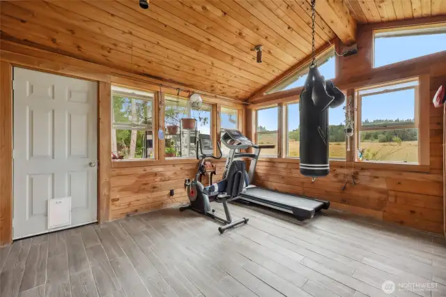 Currently being utilized as a work-out room. Use your imagination for this space. Door leads to side yard and offers access to the shops and garden space.