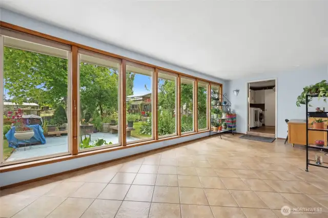 This wall of windows offers so much natural light in this secondary living space. Tile adorns most of the are.