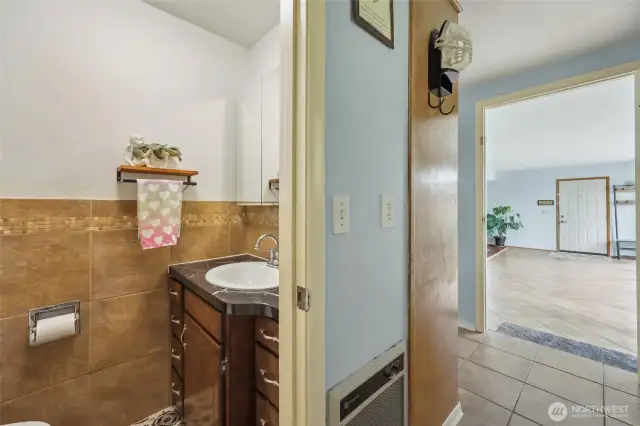 1/2 bath is located off of utility space. Dining space is to the left.
