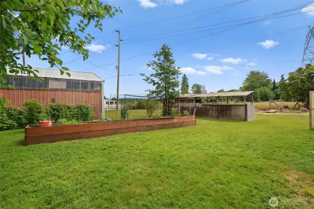 Garden space, greenhouse to the right and another outbuilding to store your equipment/tools.
