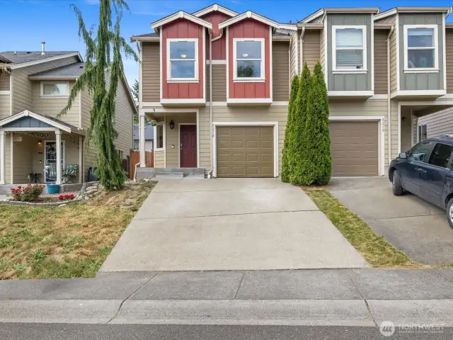 2 car driveway and 1 car garage with built-in storage racks.