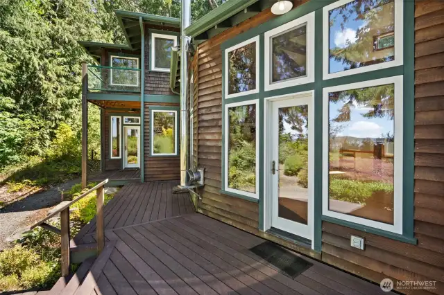 Living room access to deck & primary bedroom access to deck in the distance