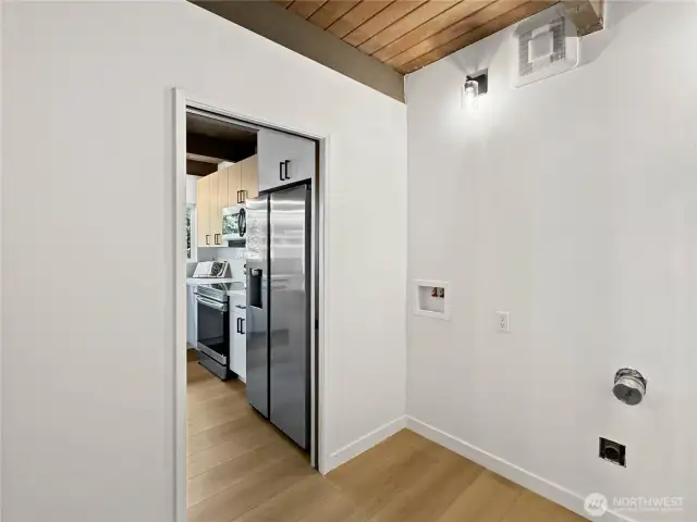 Laundry room off the kitchen connects the home to the garage and additional powder half bathroom.
