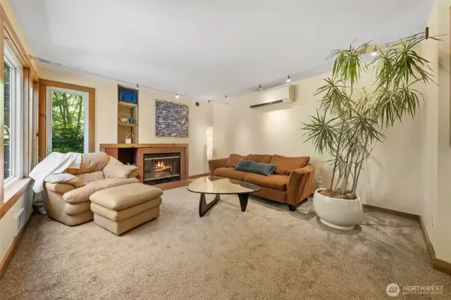 Inviting living room has a wood burning fireplace~