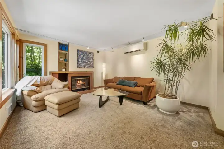 Inviting living room has a wood burning fireplace~