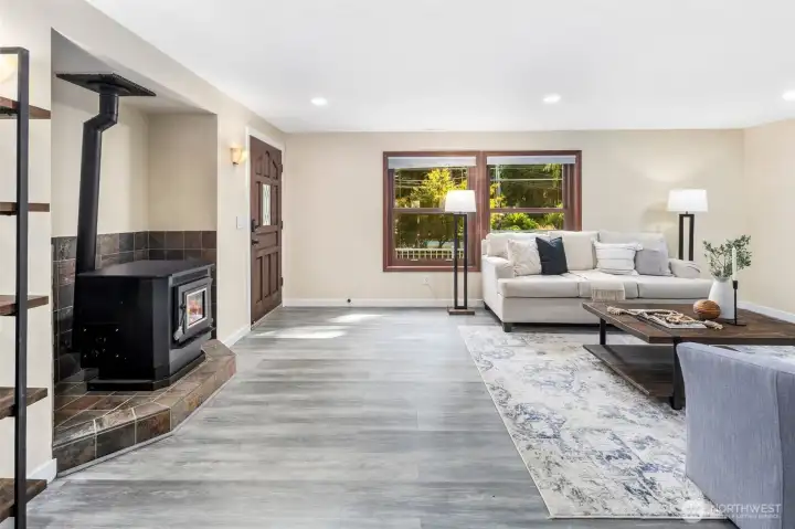 A cozy pellet stove brings warmth and charm to the living space, perfect for cooler evenings, and efficient enough to heat the whole house. Rich wood-cased window frames add timeless character, while new Levolor blinds throughout the home provide both style and convenience.