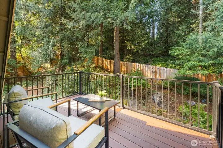 The primary suite’s private balcony is a serene retreat, with no neighboring windows in sight for complete privacy. Overlooking a lush wooded backdrop, it’s the perfect spot to enjoy morning coffee or evening relaxation—often with deer passing through the trees.