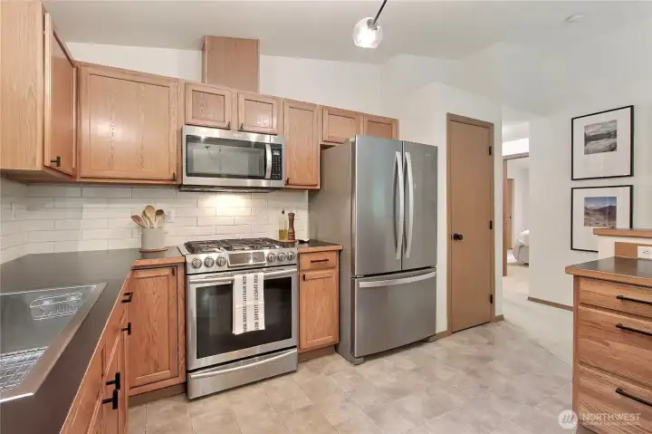 Kitchen view two, pantry to the right of your refrigerator, hallway leads to beds and baths.