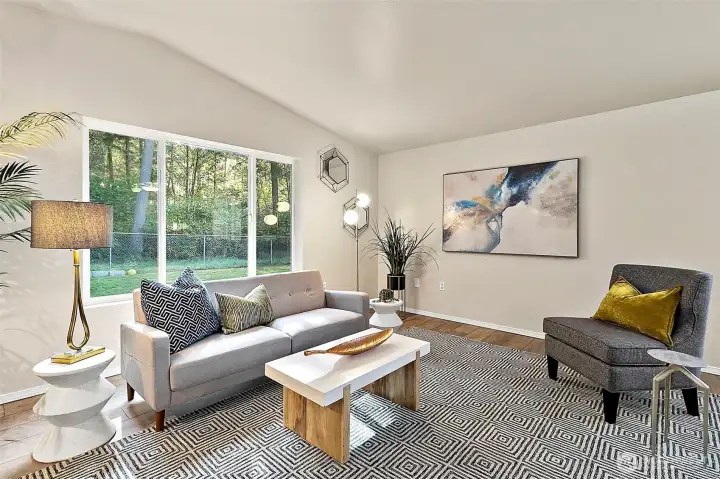 With vaulted ceilings and generous windows, the living room feels open, bright, and filled with natural warmth.
