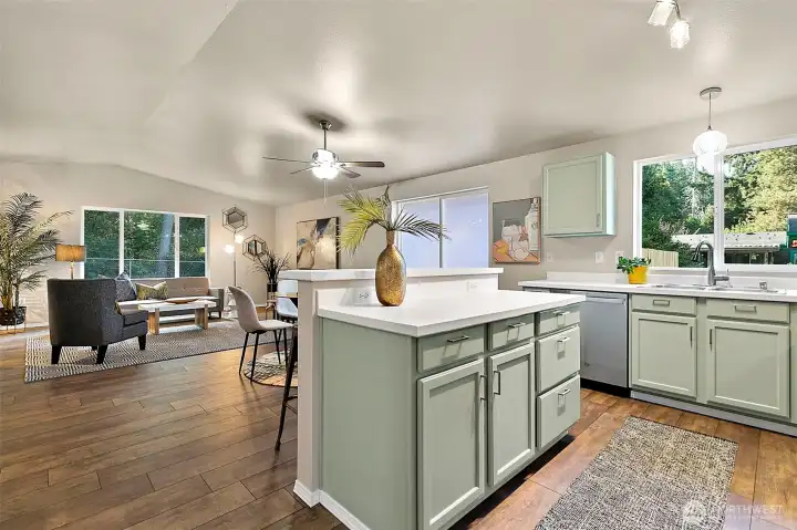 The open-concept great room, dining area, and kitchen with a welcoming breakfast bar make this home ideal for gathering, entertaining, and everyday living.