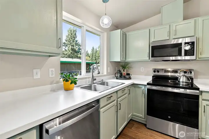 The kitchen is equipped with brand-new stainless steel appliances that all convey, offering a sleek, modern look and the convenience of a truly move-in-ready home.