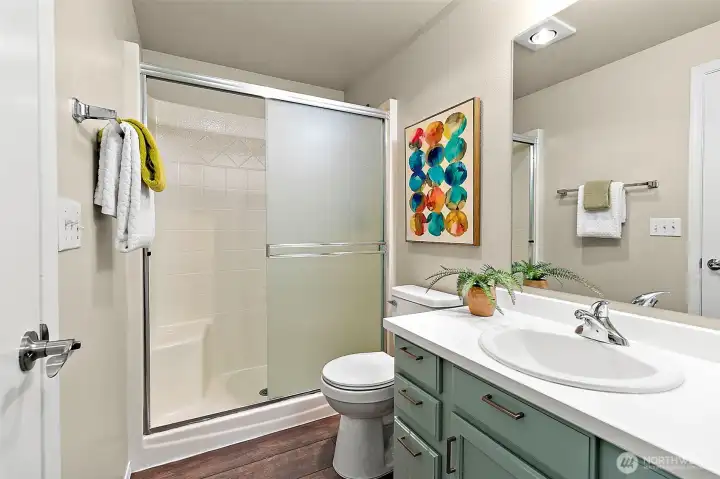 Large walk in shower and newly painted cabinets and new hardware.