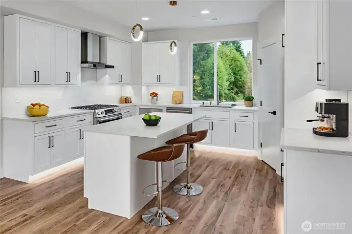 Beautiful kitchen with gas cooktop, quartz counters, and ambient lighting. Virtually staged.