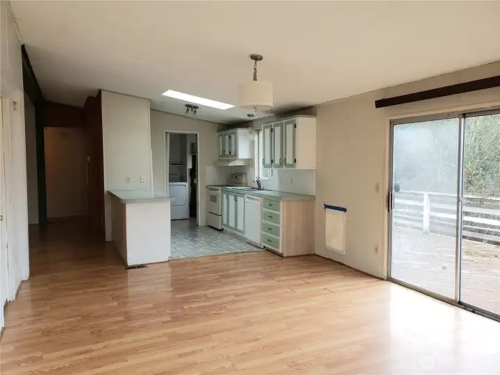 Spacious Kitchen and Second Living Room Showing Skylight, Cathedral Ceiling, Skylight Laminate Flooring.