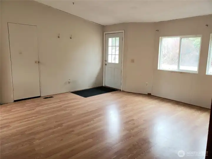 Picture of the Huge Living Room Showing Laminate Flooring Looking at the Front Entry Door.