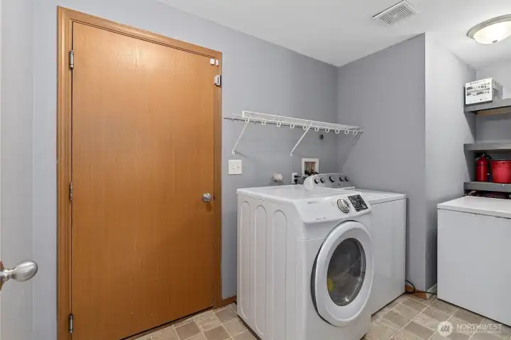 Laundry room with storage leads to 2-car garage