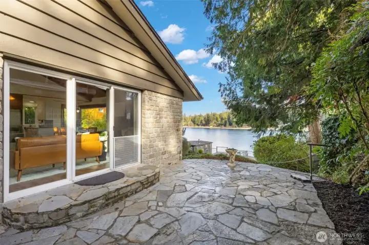 Side patio with walkway down to the water