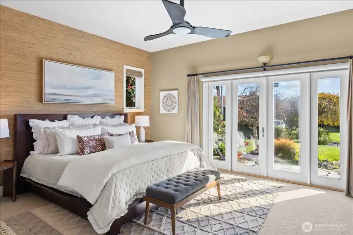 Luxe primary suite with French doors to the privae garden space