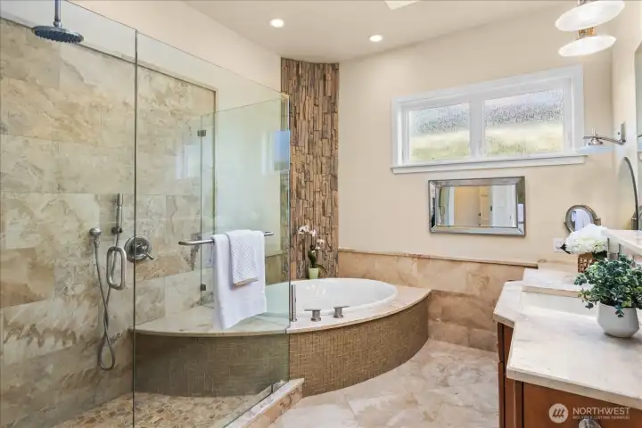 Spa-inspired primary bath with soaking tub and custom walk in shower