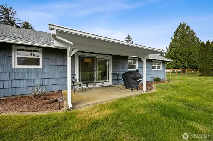 Plenty of room for a grill, outdoor dining, or a comfortable seating setup, and the beauty of having it covered is the Northwest reality check, when a little rain rolls in, your plans do not have to change. It extends the living space in a way that actually gets used. The cedar siding wrapping around the back of the home adds wonderful texture and warmth too, giving the exterior that classic natural character people are always drawn to. Cedar has a timeless quality, but it is also valued for durability and insulating properties, which makes it more than just a pretty face.