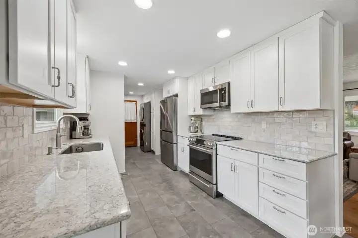 The Bosch refrigerator brings serious function with its French door upper section, extra refrigeration drawer and bottom freezer, a configuration that feels almost custom once you use it. The pantry with pullout shelving adds another layer of smart storage, making the galley layout even more efficient. Everything has a place. And the stackable LG washer and dryer staying with the home is another practical win, integrated into the flow without stealing attention. This view reinforces something important about this remodel, it was not just about making things pretty. It was about making daily life easier.