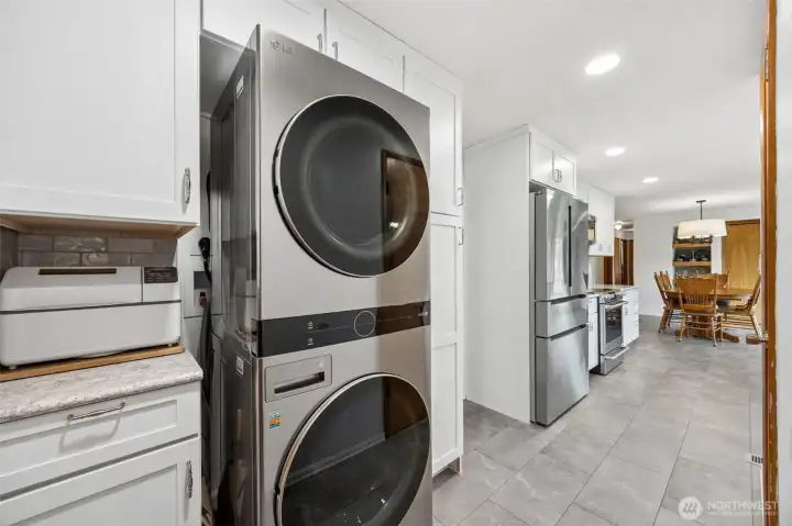 The stackable high-efficiency LG washer and dryer stay with the home, tucked neatly into a setup that feels integrated, not improvised. Right beside it, the pantry storage keeps daily essentials organized and within easy reach, proving efficient can still feel elegant. And that really is the story here, a mid-century rambler reimagined for contemporary living without losing the simplicity that makes one-story homes so appealing in the first place. No wasted space, no awkward excess, just smart design doing more with what it has.