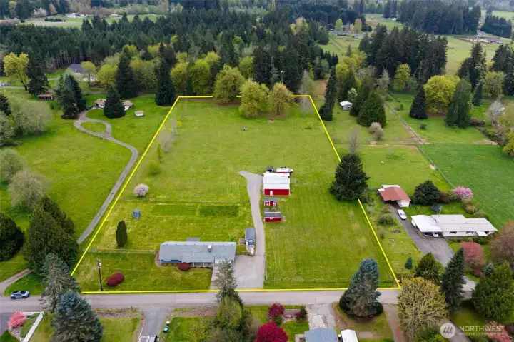 Approximate lot lines help you see just how much usable, level ground comes with these 4.81 acres, and this is not acreage disappearing into ravines or wetlands. This is open, cleared land you can actually use. There is a newer gate to the back of the property on the right, another gate at the back left, plus the survey marker positioned at the back right corner near that rear gate, giving helpful reference points for future planning. Even better, spare gates and posts stay with the property, which feels a little like getting handed extra pieces to keep building the dream. Animals, cross fencing, garden expansion, equipment access, there is room for all of it here.