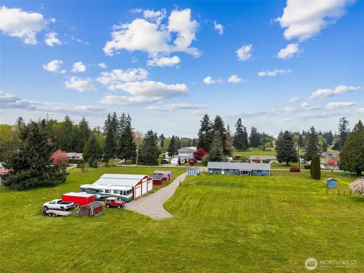 From above, you can see how the home, outbuildings and fenced areas are laid out with real intention, not scattered, but working together as a cohesive property. The fenced backyard creates a defined space around the home, while the larger acreage opens beyond. Off to the right, that little blue structure is the well house, home to the well pump and another reminder this property has meaningful infrastructure already in place. It is easy to focus on the charm here, but there is substance too. And from this vantage point, you start to appreciate how much has already been created, house, shop, supporting buildings, pasture, systems, all layered into something that feels much bigger than a simple country home.