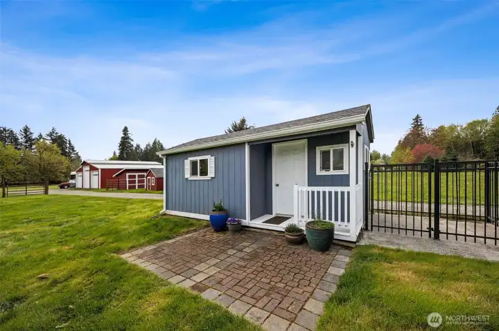 Just steps from the back door, it has all the charm of a tiny cottage with that sweet front porch, windows, and cute paver patio setting the scene. Painted to match the home, it feels intentional, not like an afterthought dropped in the yard. Today it serves as potting shed and storage, with a doggie door connecting to the run off to the right, giving pets indoor-outdoor access that is frankly pretty fabulous. But it is easy to imagine this becoming something more, a home workspace, art studio, garden retreat, maybe the most charming little office you have ever Zoomed from. It is functional, flexible, and absolutely adorable.